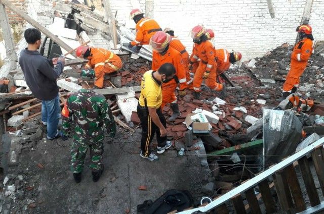 EVAKUASI: Petugas Dinas Pemadaman Kebakaran bersama Polsek Gayungan dan Koramil setempat melakukan pencarian korban.